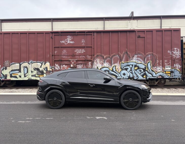 Armormax armored Lamborghini Urus bulletproof luxury SUV driving on road in Utah with mountain backdrop.