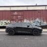 Armormax armored Lamborghini Urus bulletproof luxury SUV driving on road in Utah with mountain backdrop.