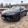 Armormax armored Lamborghini Urus bulletproof luxury SUV driving on road in Utah with mountain backdrop.
